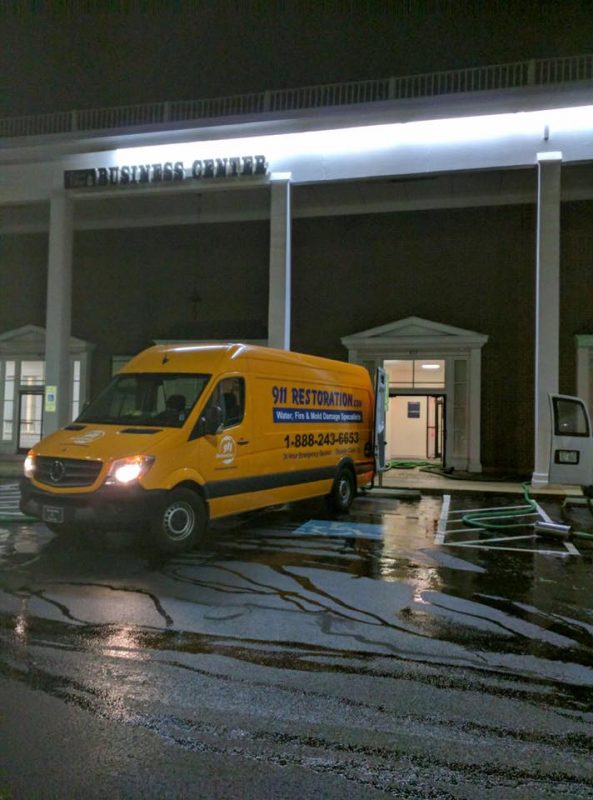 911 Restoration truck pulling out of commercial property