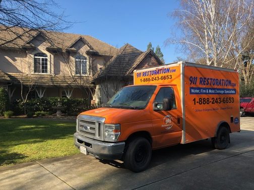 911 Restoration mold removal truck in front of home